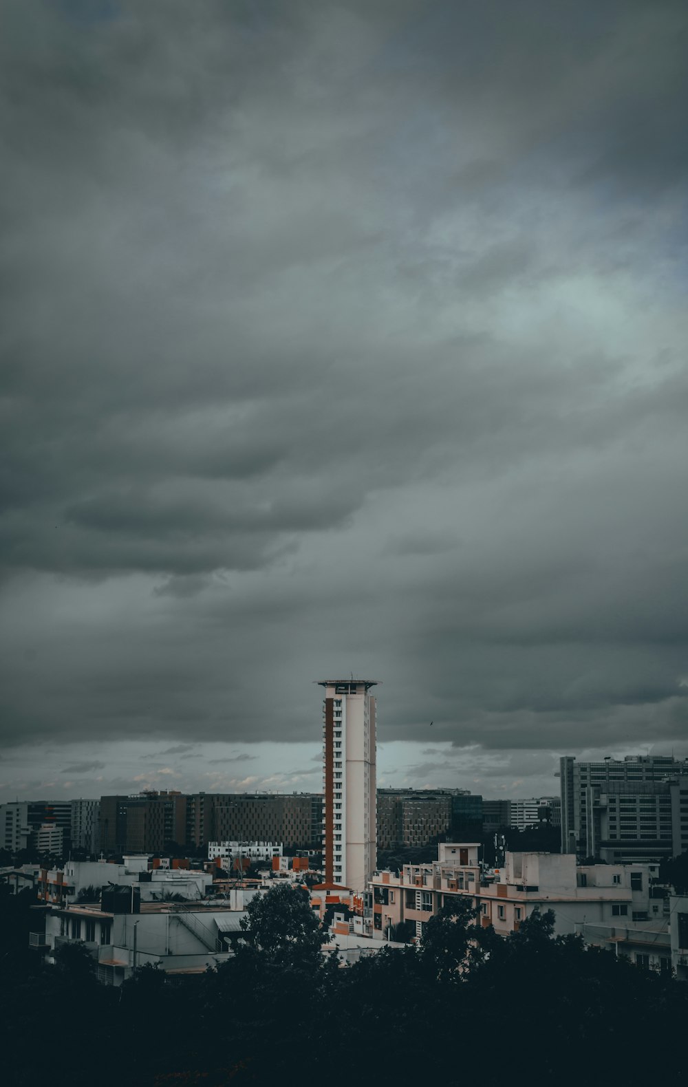 city skyline under gray cloudy sky during daytime