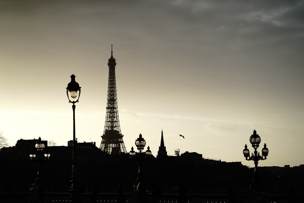 silhouette of people walking on street near eiffel tower during sunset