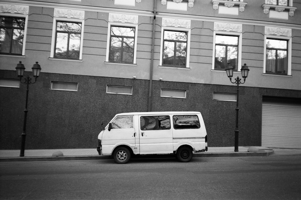 white van parked beside building