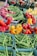 A vibrant assortment of fresh organic fruits and vegetables displayed in a rustic basket.