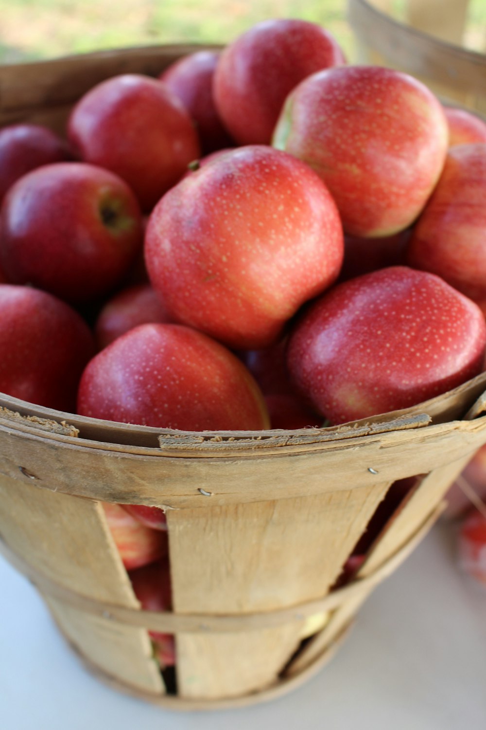 red apples in brown wooden basket