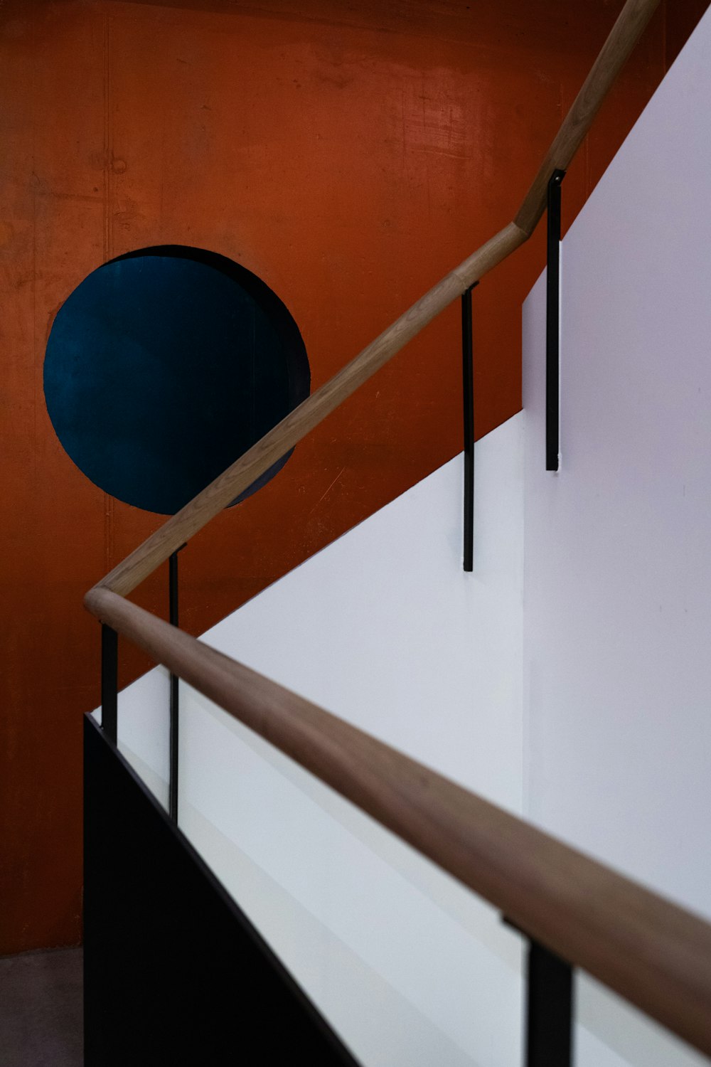 blue round ball on white concrete staircase