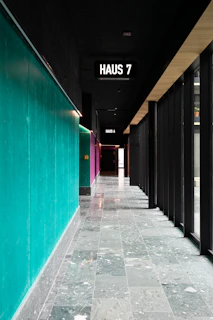 Modern boarding house hallway with visible WiFi access points installed.