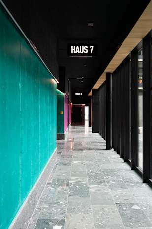 Modern boarding house hallway with visible WiFi access points installed.