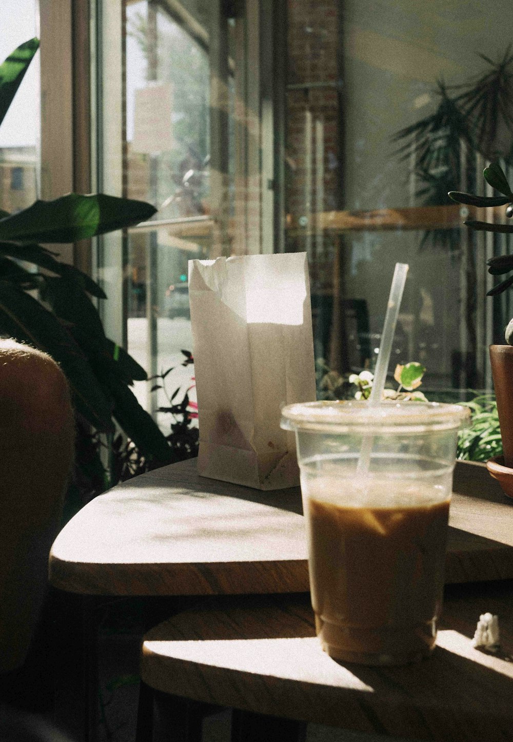 clear plastic cup with brown liquid