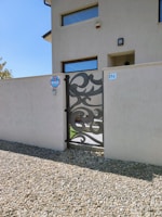 A residential home featuring a stylish automatic gate installation.
