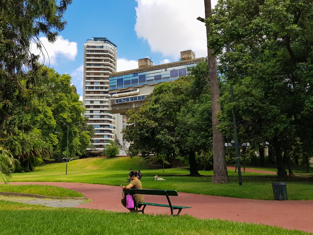 woman in pink shirt sitting on bench