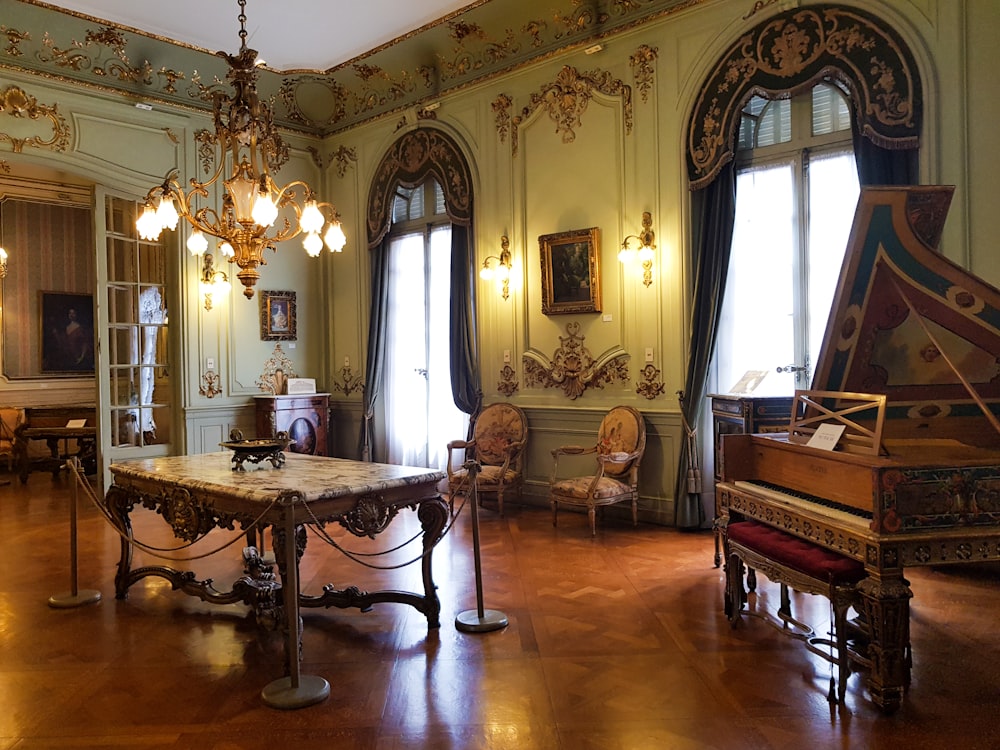 brown wooden upright piano on brown wooden floor