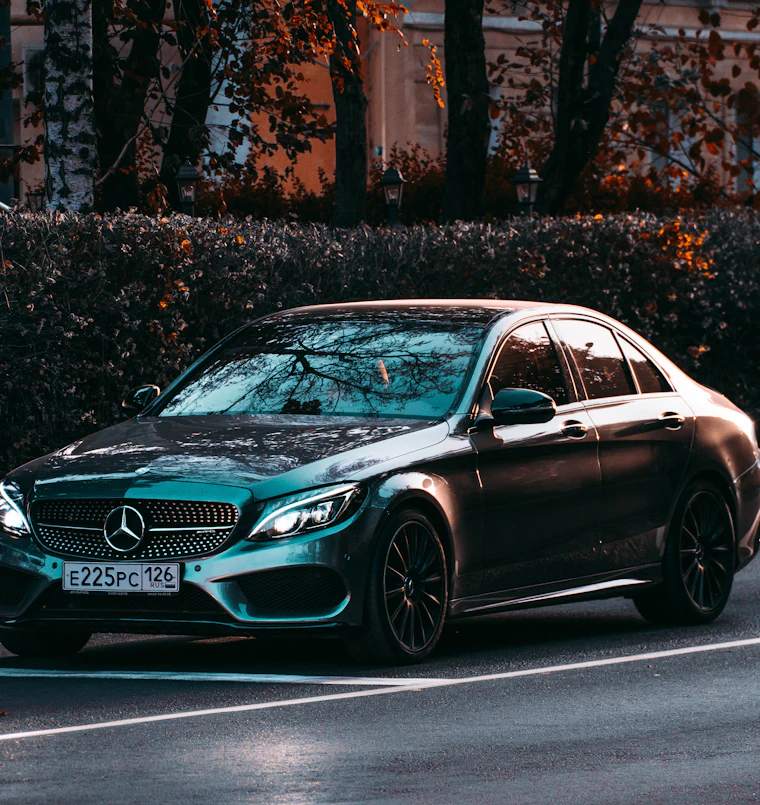 Modern dark green Mercedes saloon photographed head-on