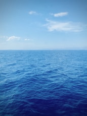 blue ocean under blue sky during daytime