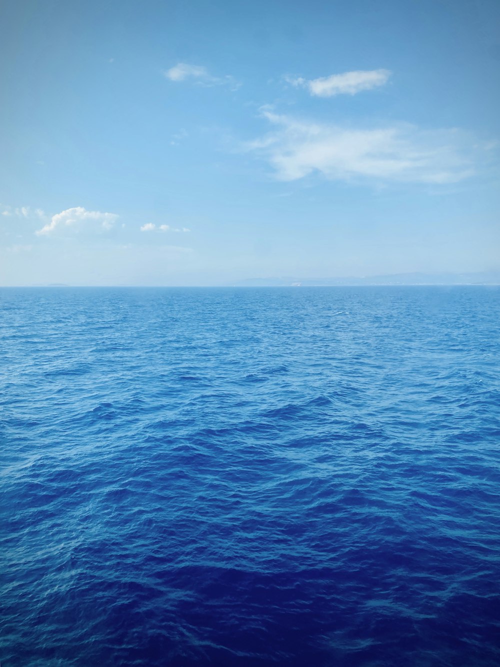 blue ocean under blue sky during daytime