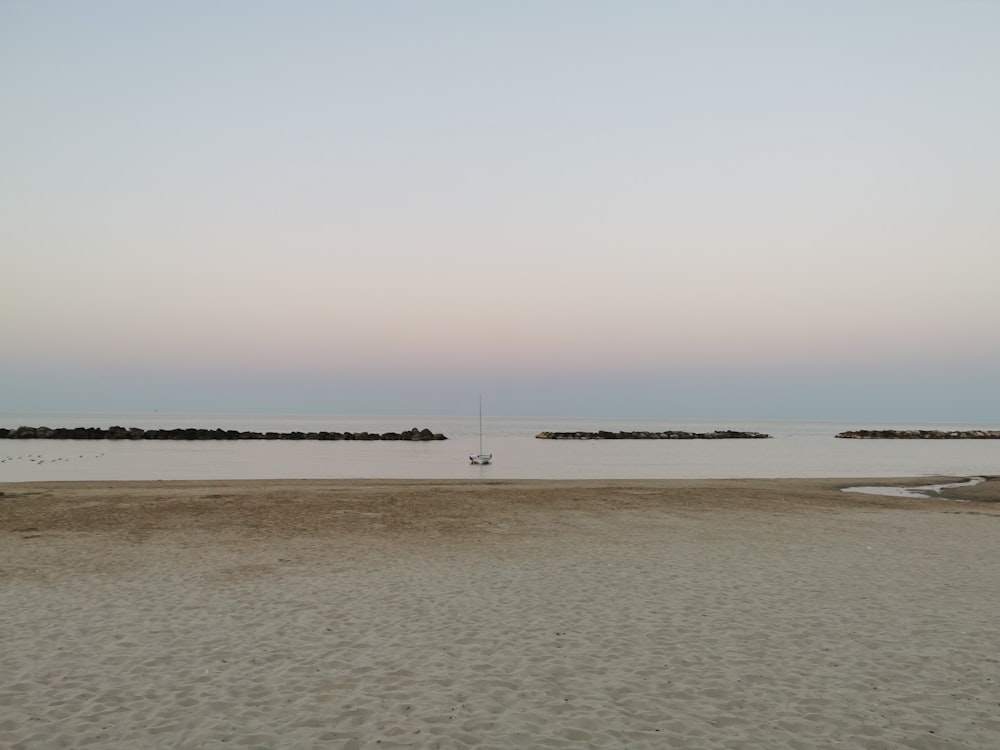 person walking on beach during daytime