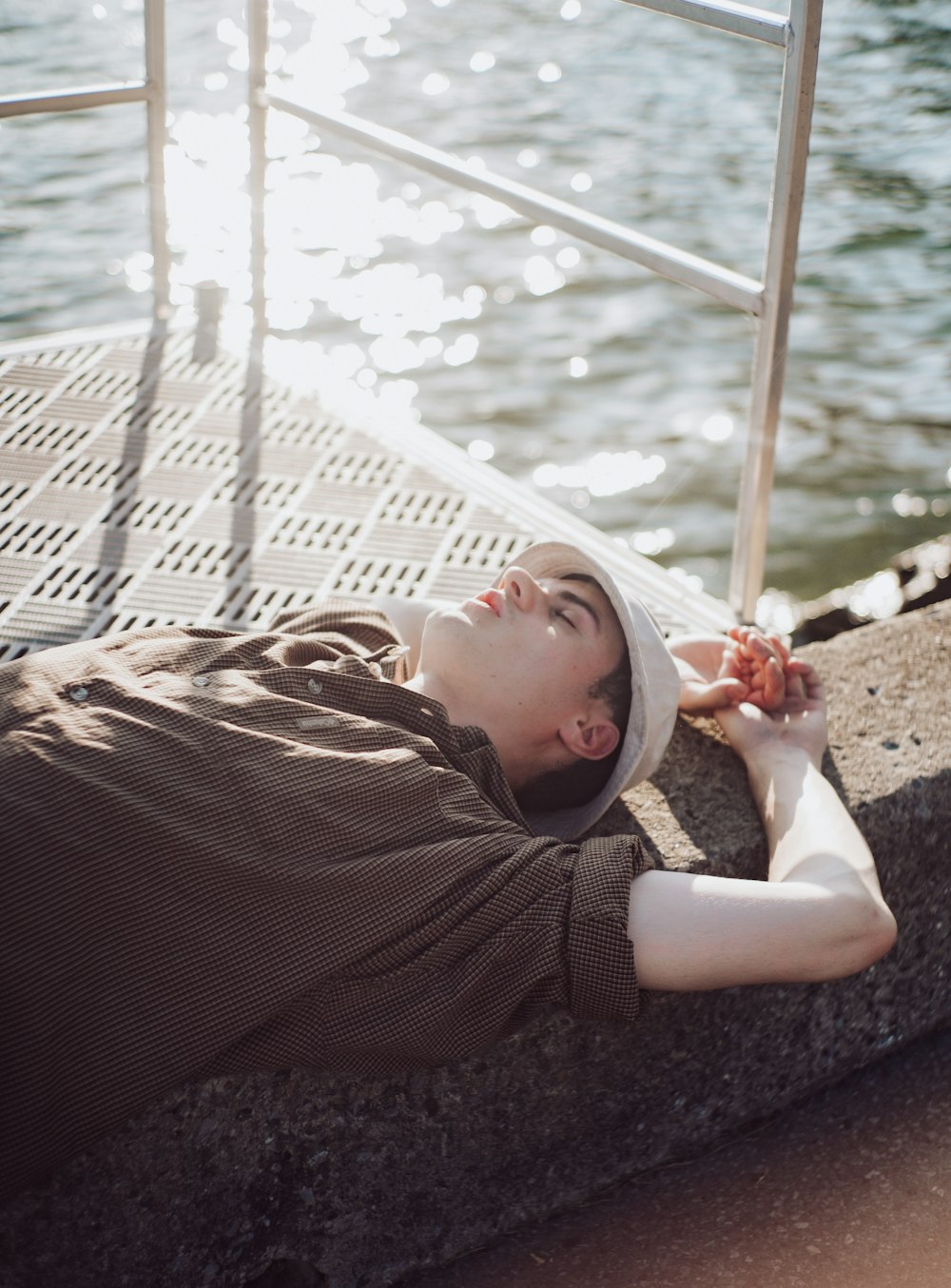 woman in brown long sleeve shirt lying on white hammock