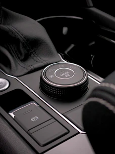 Close-up of a hand choosing a car model from a sleek interactive display.