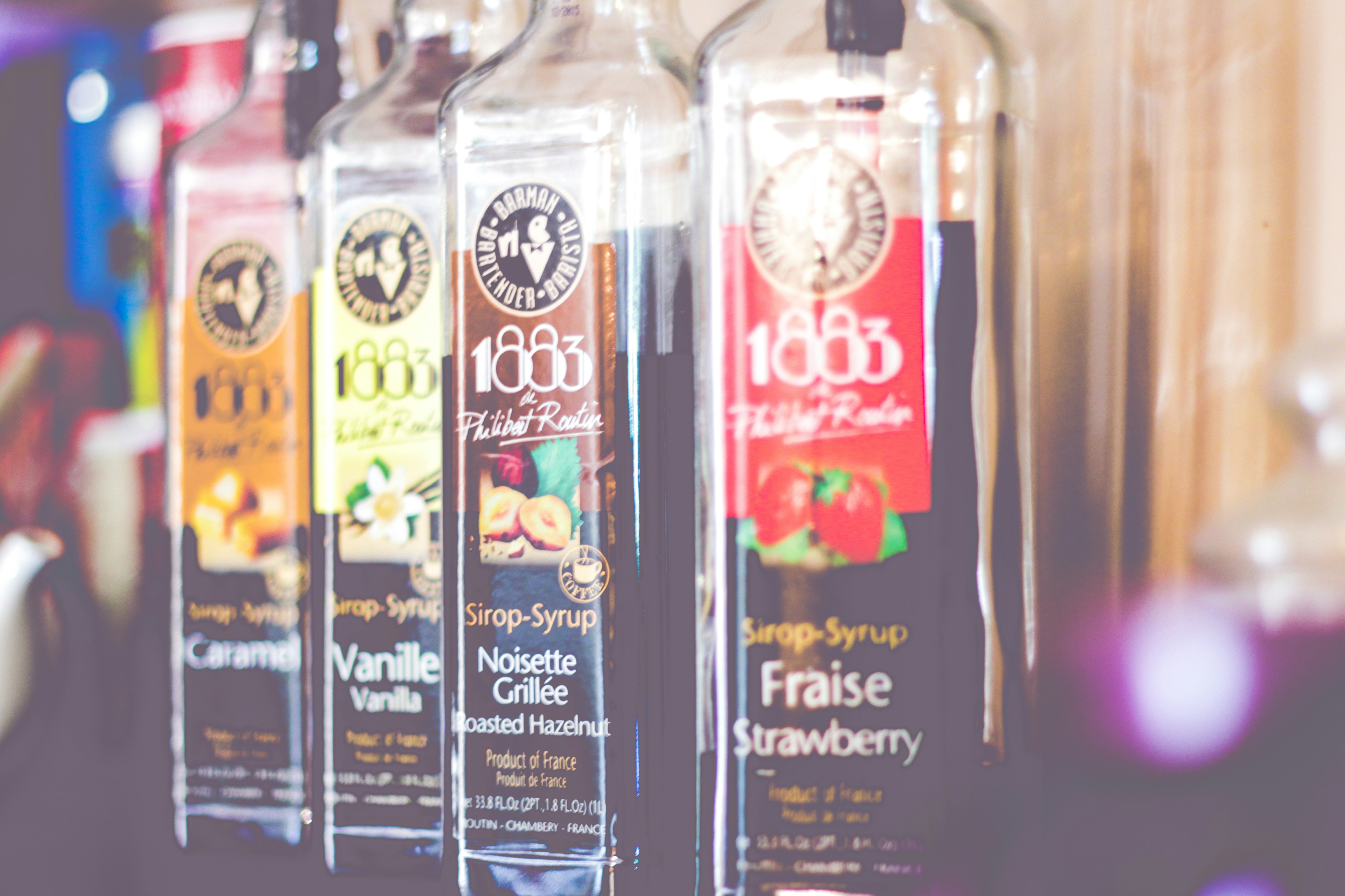 three bottles of juice are lined up on a shelf