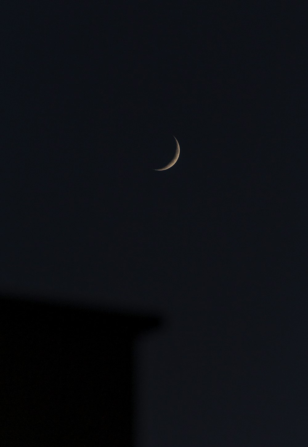 white crescent moon in dark night sky