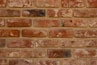 Hand-molded brown brick slips arranged neatly, showing rustic texture and rich color.