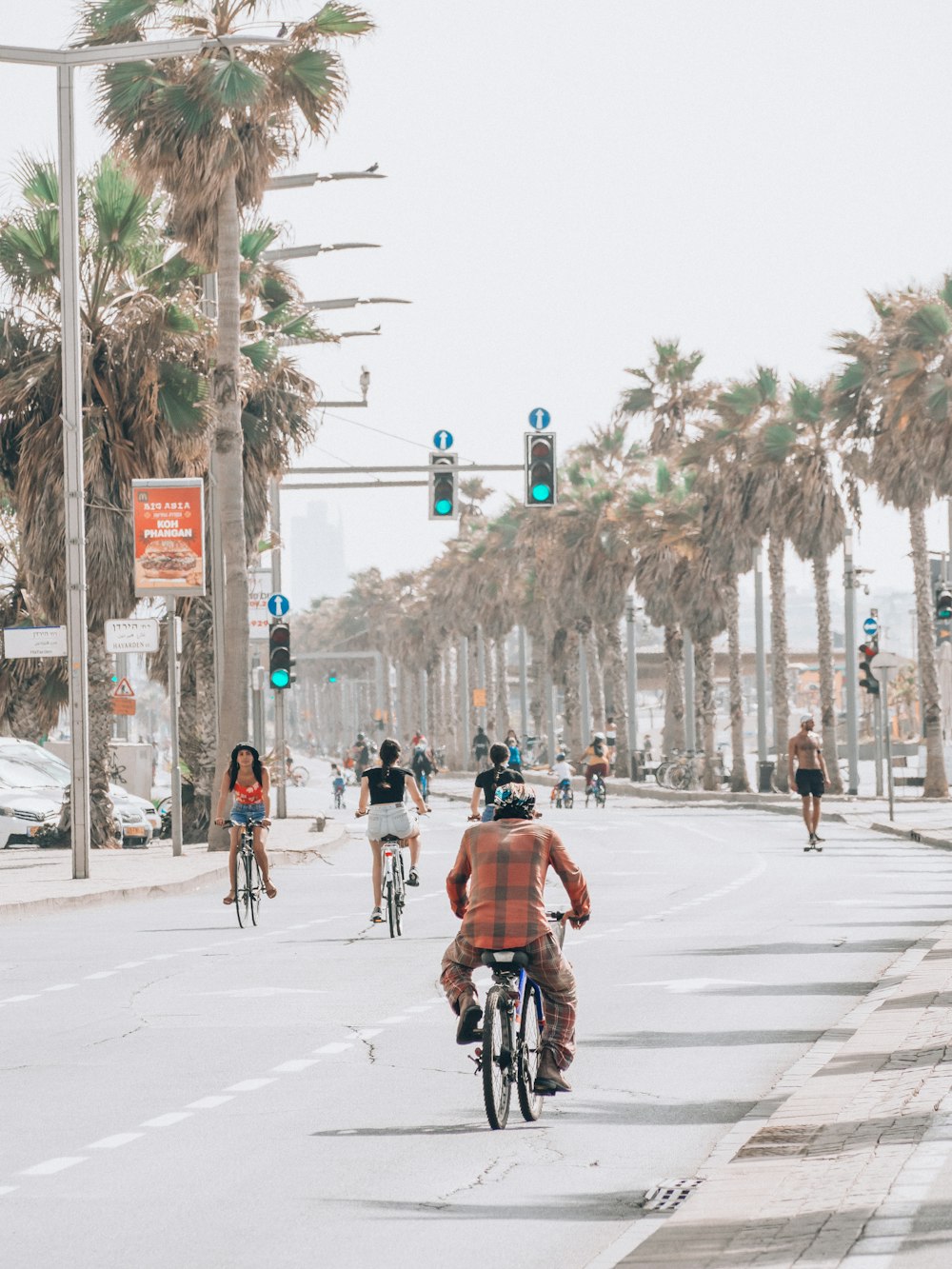 people riding bicycle on road during daytime