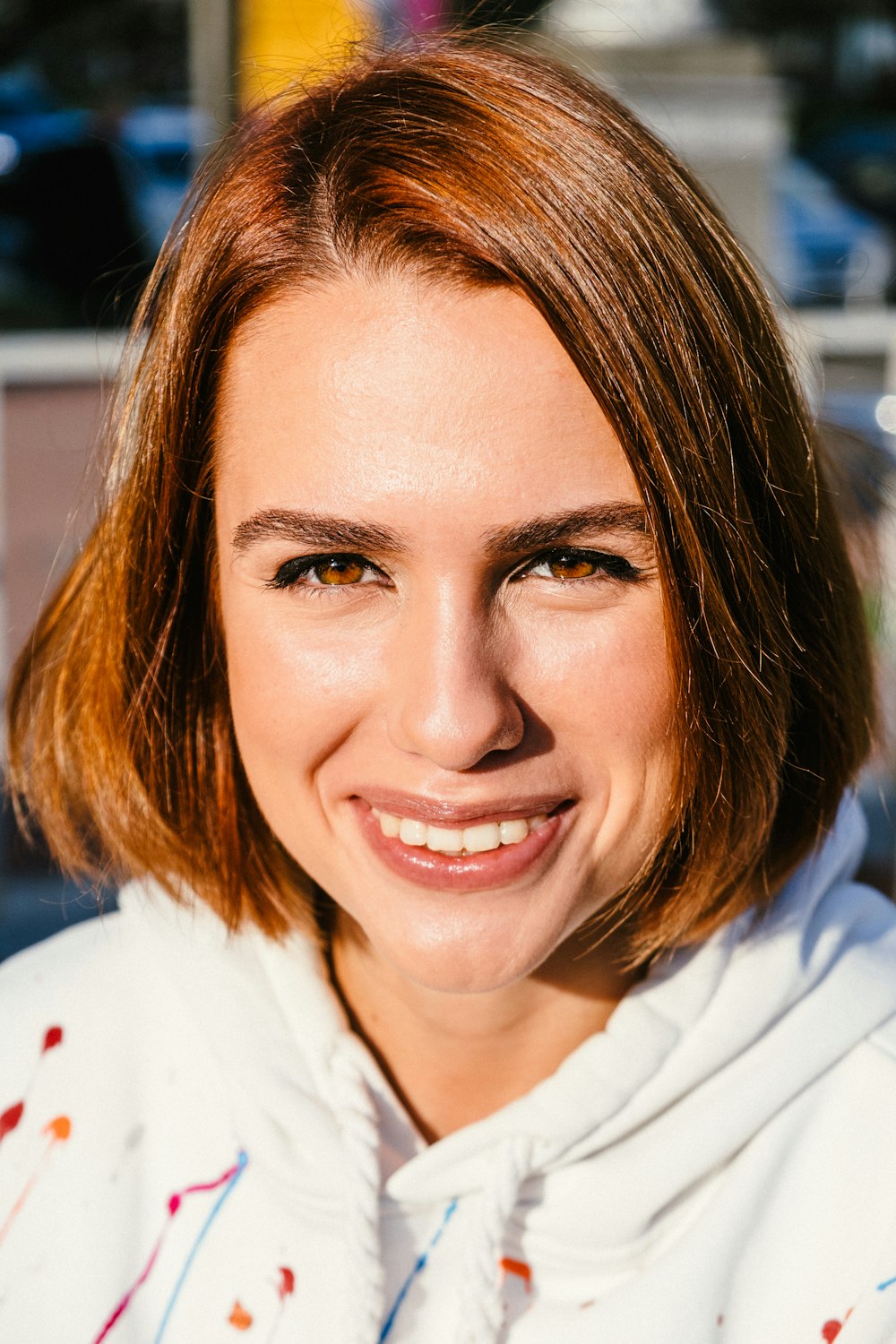 woman in white collared shirt smiling