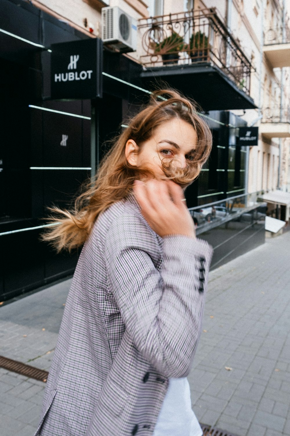 woman in gray and black striped long sleeve shirt