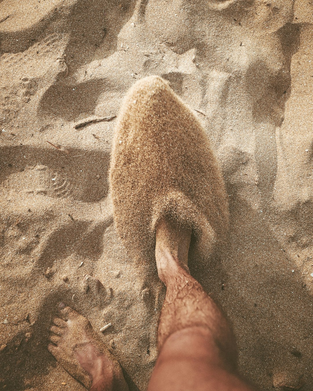 person standing on brown sand during daytime