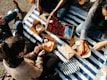 A group of friends enjoying a picnic in casual outfits.