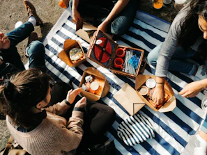 A diverse group of friends enjoying a picnic in the park.