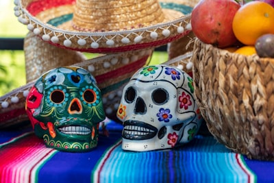 white and red ceramic skull figurine day of the dead zoom background