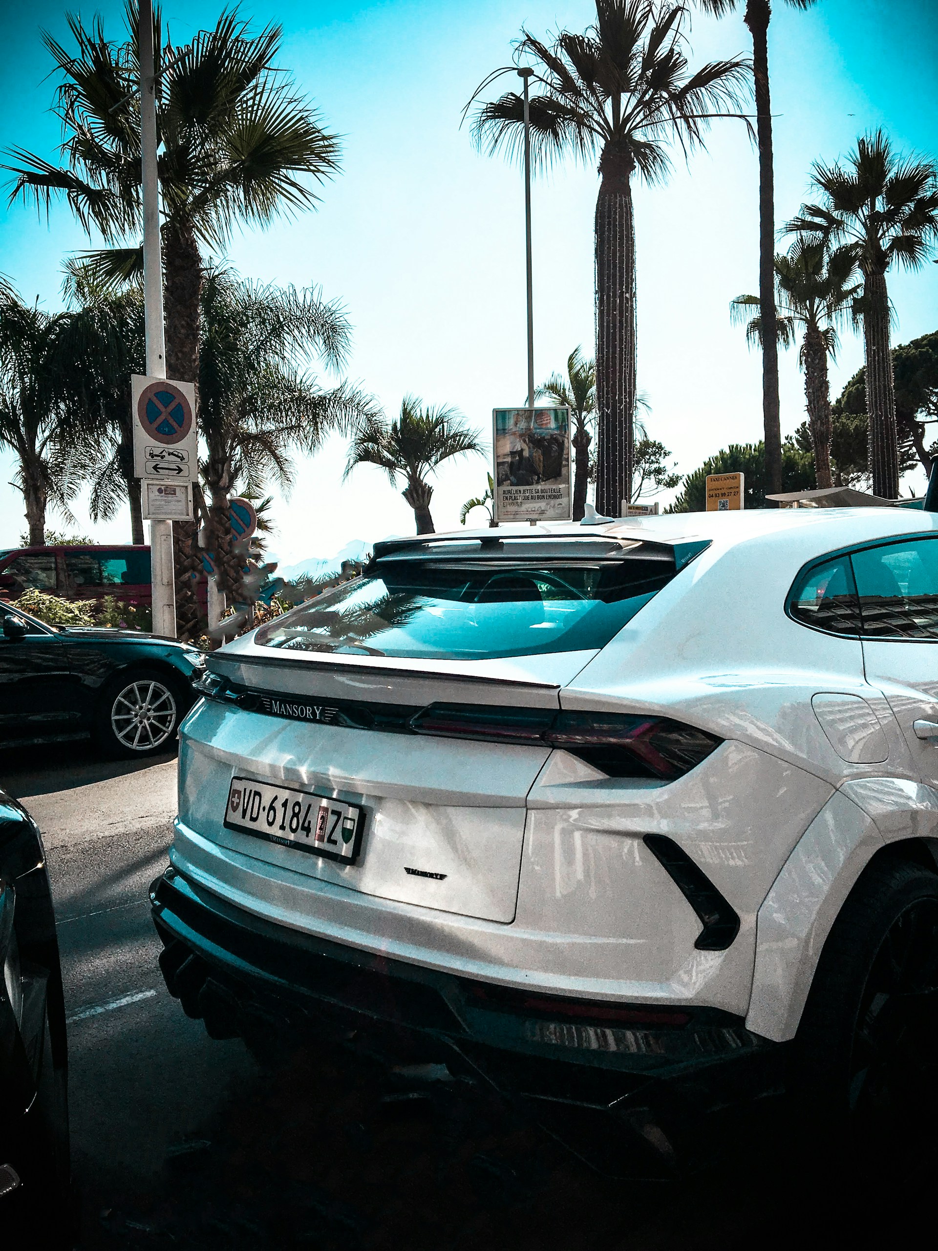 white porsche 911 parked on parking lot during daytime