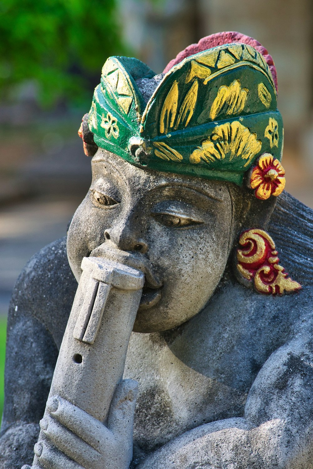 person wearing blue green and yellow floral headdress