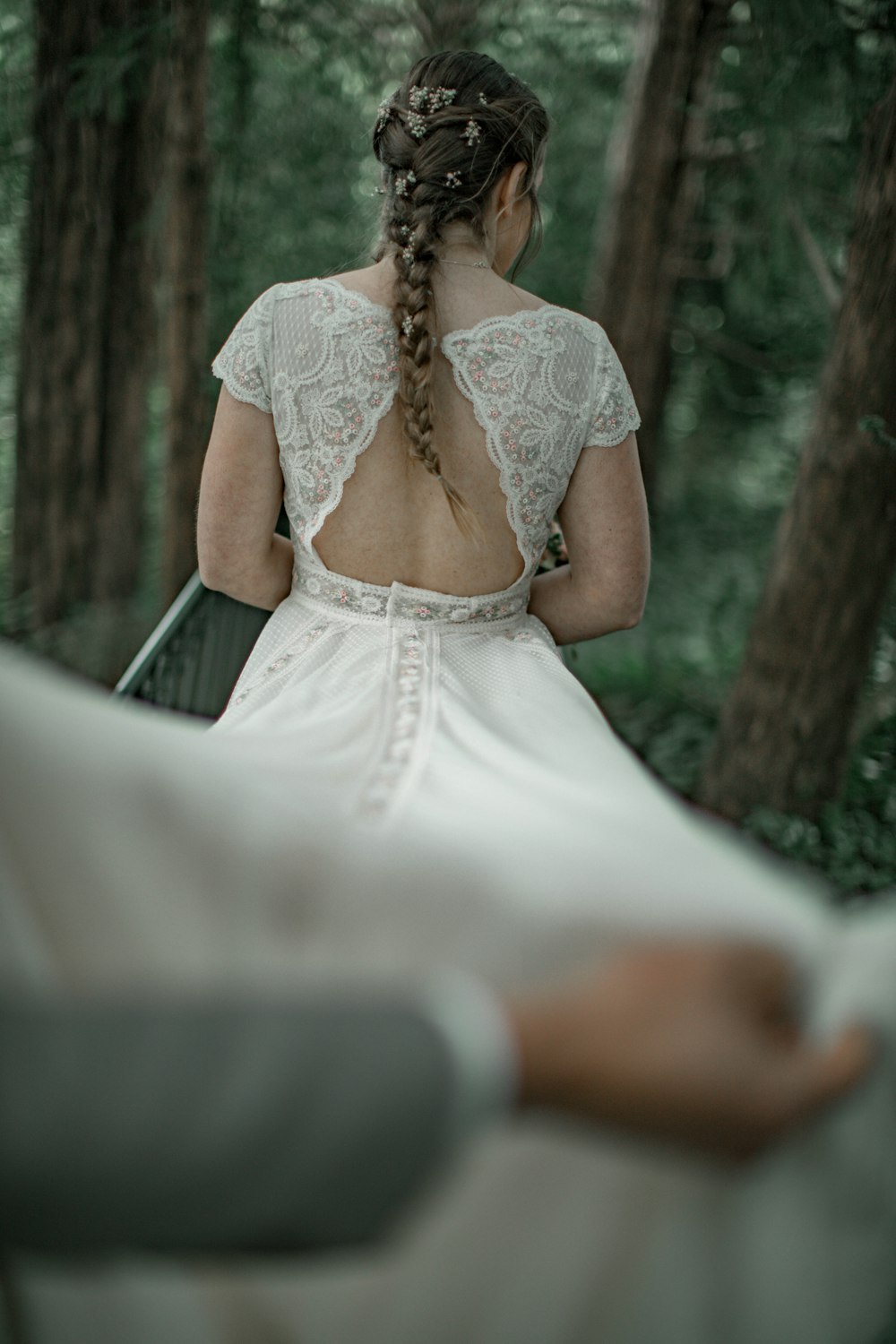 나무 근처에 서 있는 하얀 드레스를 입은 여자