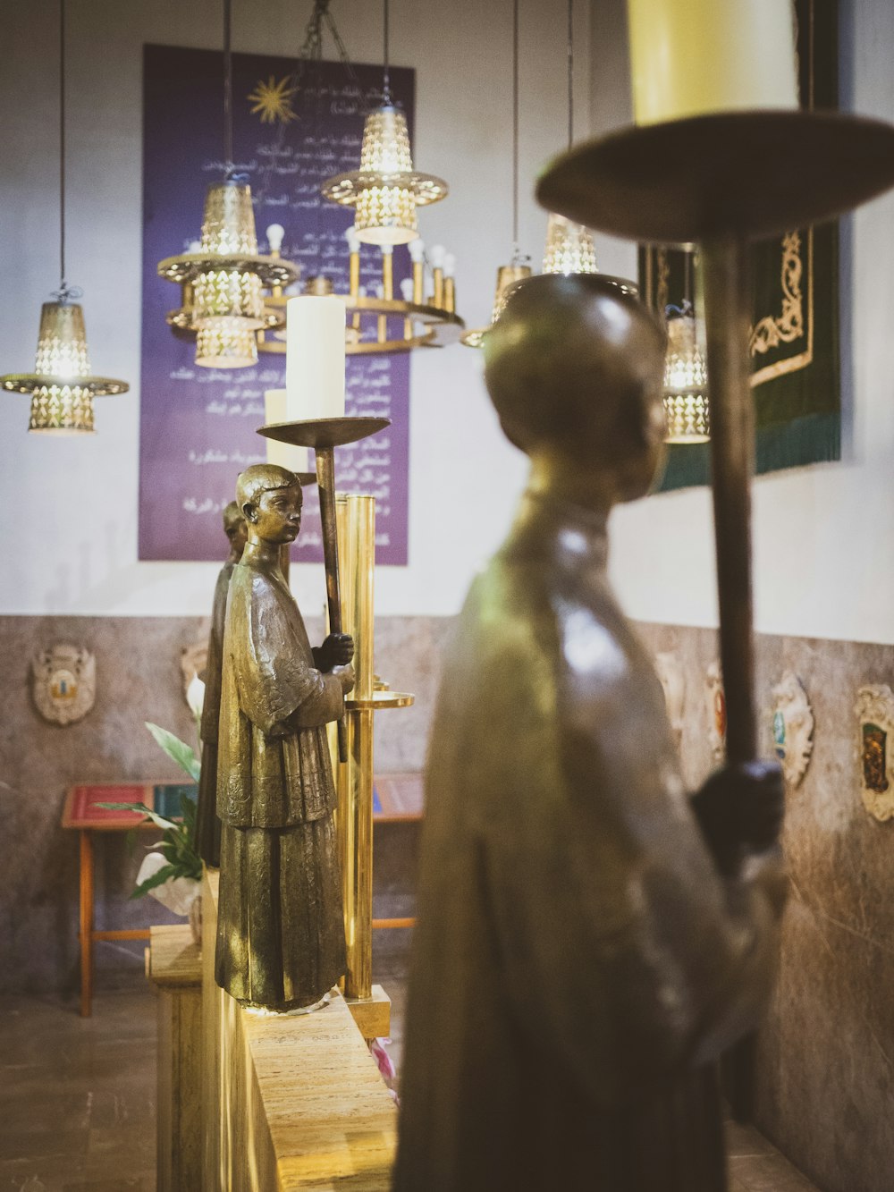 gold buddha statue near brown wooden table