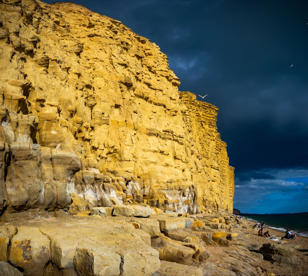 brown rock formation near body of water during daytime