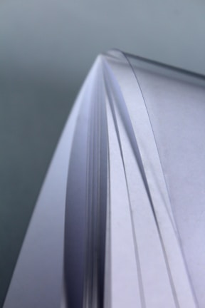 Stacks of various sizes of high-quality office paper close-up.