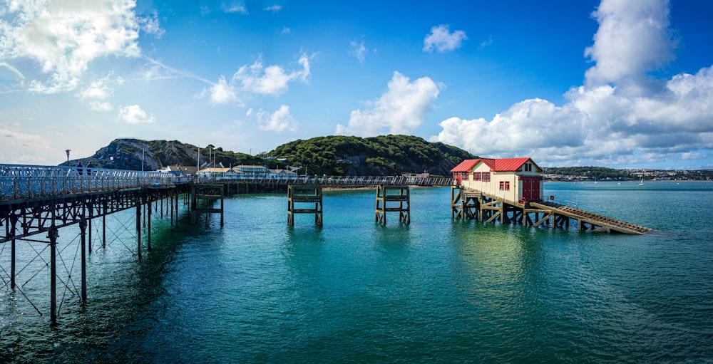 blue and brown wooden houses on sea dock under blue sky during daytime