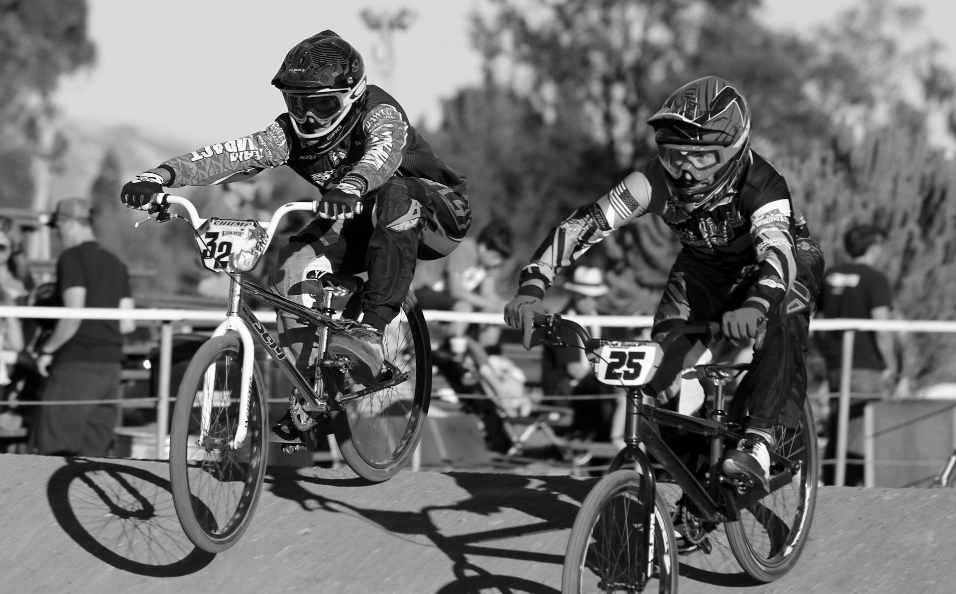 grayscale photo of 2 men riding bicycle