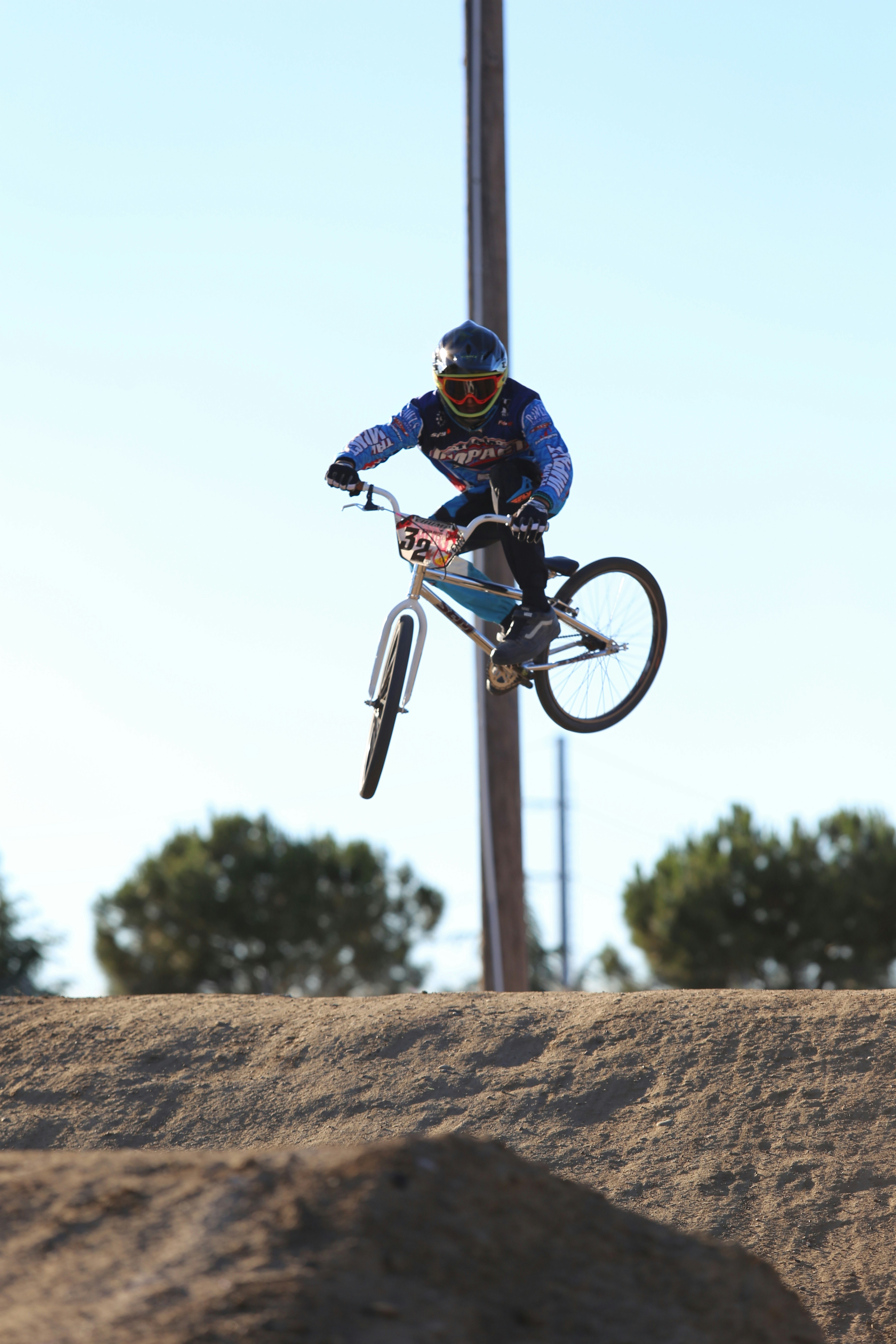 man in blue and black jacket riding on black and red mountain bike