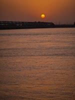 Sunset view over the serene Durgapur Barrage with water reflections.