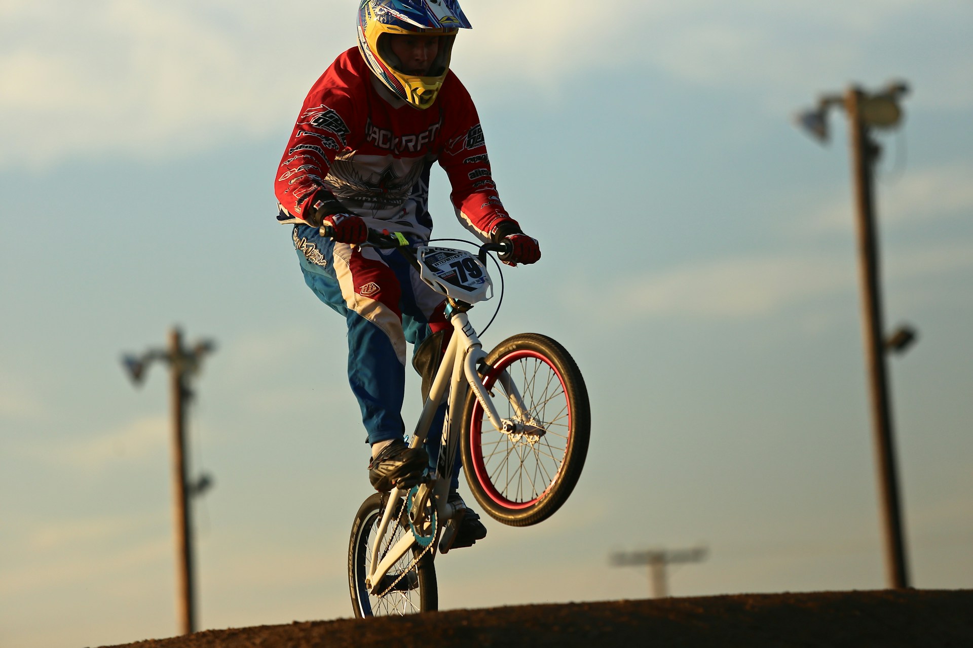 man in red and black jacket riding on bicycle during daytime