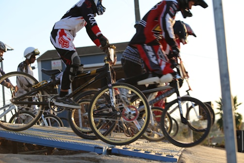 man in black and red jacket riding on bicycle