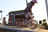 A group of BMX riders gathering at the entrance of Ruckstrack in Hermosillo during sunset