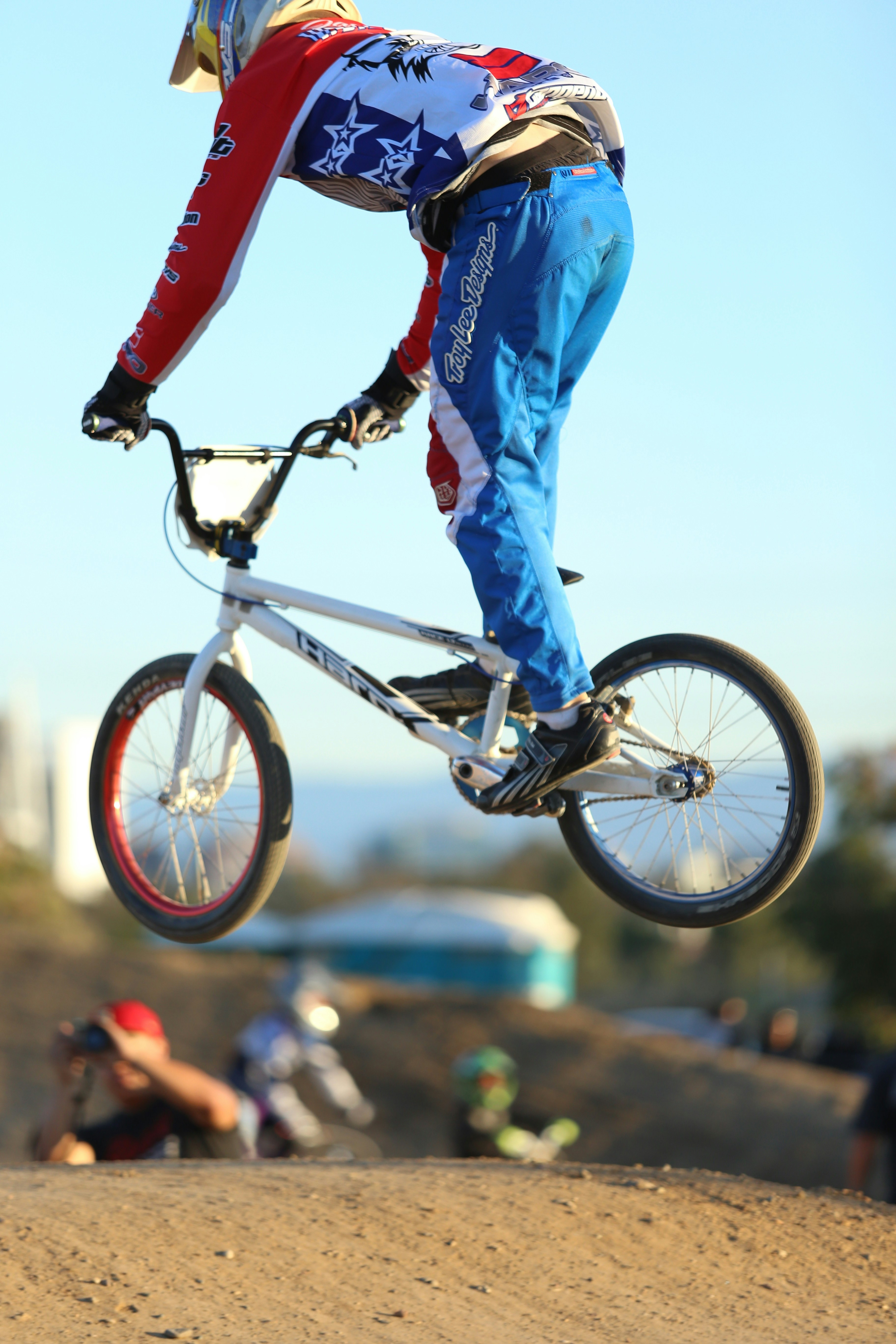 man in blue jacket riding on blue and black mountain bike