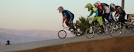 A group of bikers racing down a steep hill.