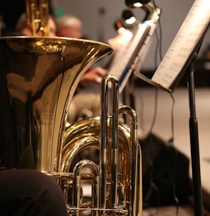 brass trumpet near white printer paper