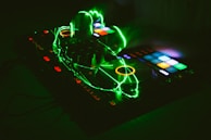 A sleek DJ controller glowing with LED lights, fingers adjusting knobs in perfect rhythm.