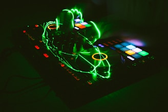 Technician repairing a DJ controller with vibrant colorful background.