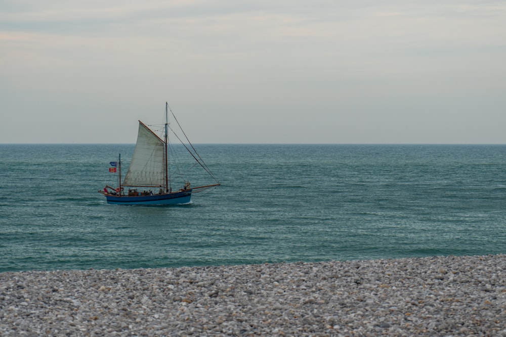 blue and brown sail boat on sea during daytime