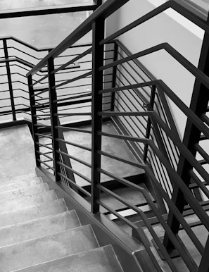 Charcoal rendering of an elegant staircase integrated with subtle blueprint markings.