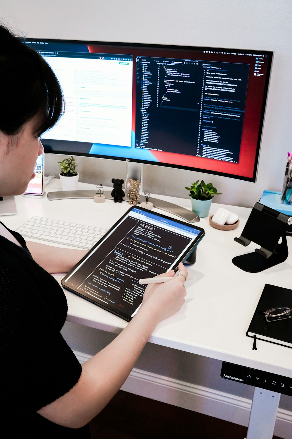 woman in black shirt using macbook pro