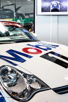 A smiling customer applying a Mobiluz sticker to their car door, capturing the personal connection to the brand.